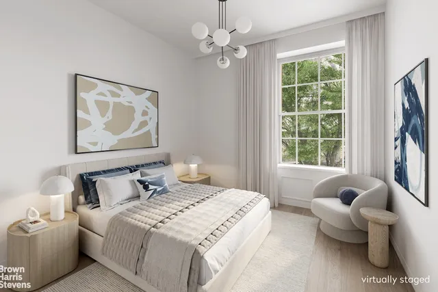 a spacious bedroom with a bed a fireplace and a large window