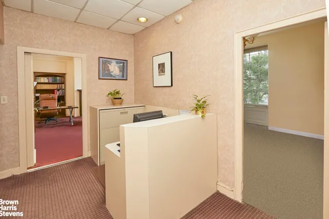 a bedroom with a bed couch and window