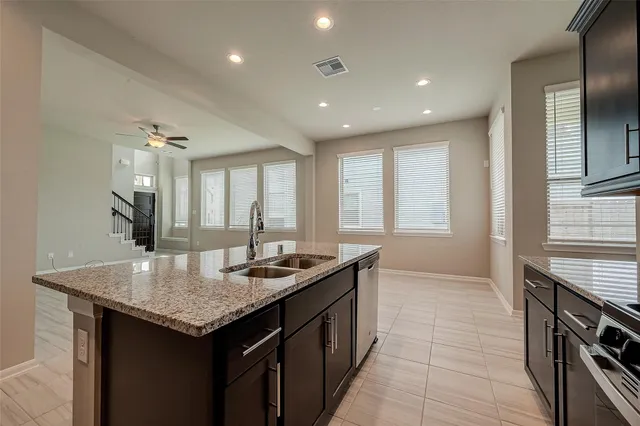 a kitchen with granite countertop a sink and a stove
