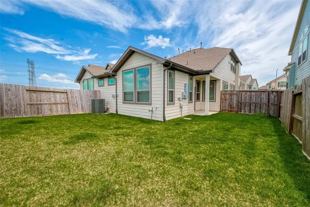 a view of a house with a yard and porch