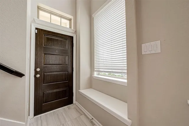 a bathroom with a tub and a window