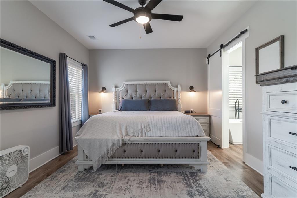 2250 Sperin Road Ball Ground, GA 30107 - Photo 23 of 56 a bedroom with a bed and wooden floor