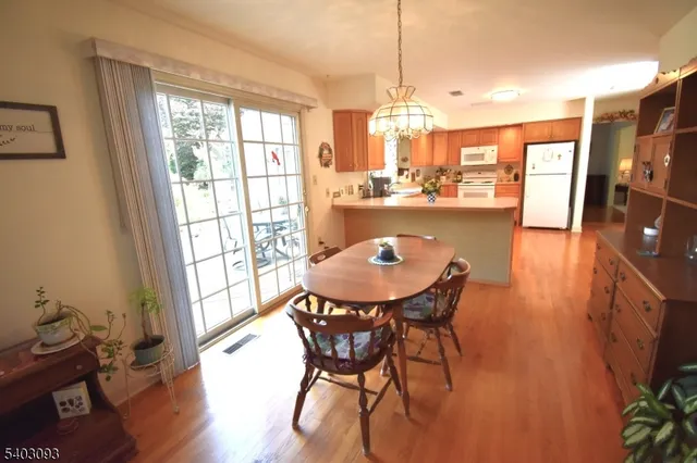 a dining room with furniture and wooden floor