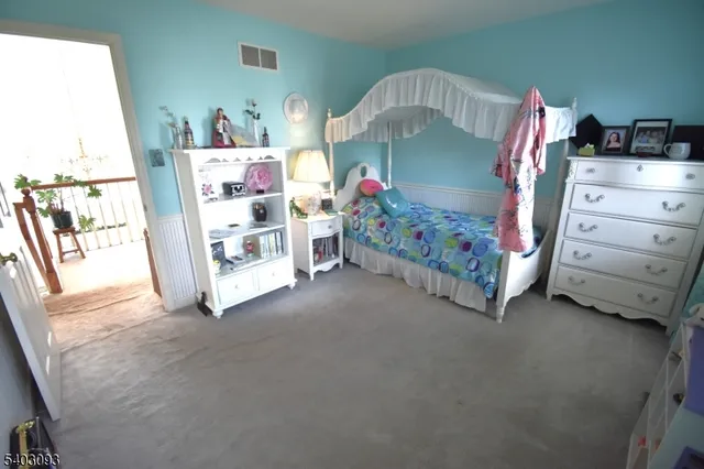 a bedroom with a bed and a baby crib