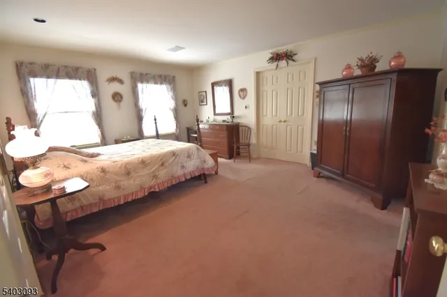 a bedroom with a bed dresser and a large mirror