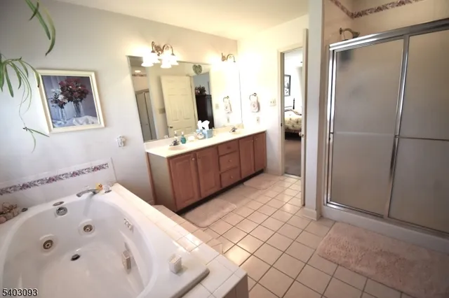 a bathroom with a tub sink and mirror