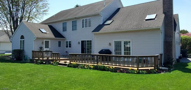 a view of a house with a yard and sitting area