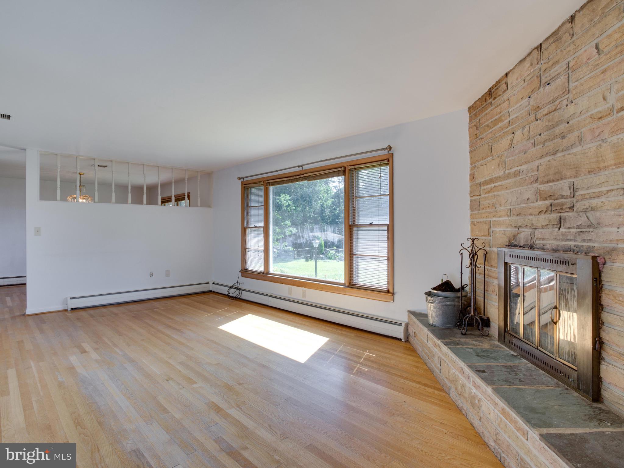 13750-h G H G Trueman Road Solomons, MD 20688 - Photo 14 of 48 family room hardwood and fireplace