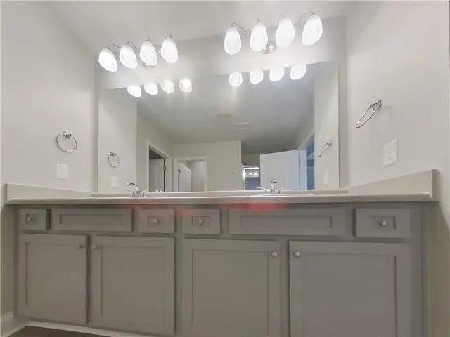 a view of cabinets a sink and a chandelier in a kitchen