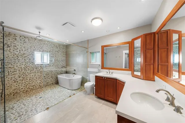 a bathroom with a sink mirror and a bathtub