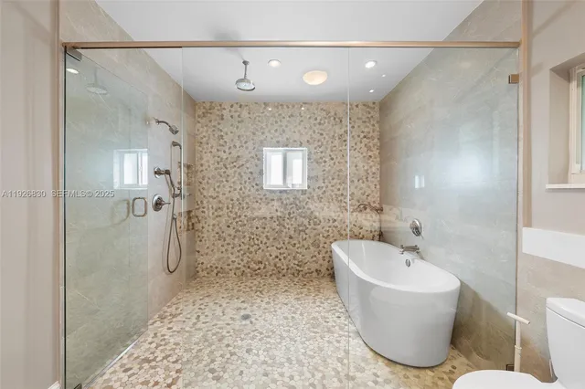 a bathroom with a bathtub and shower