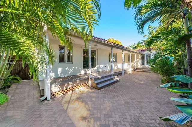 a view of patio with table and chairs and potted plants