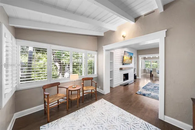 a living room with furniture and large windows