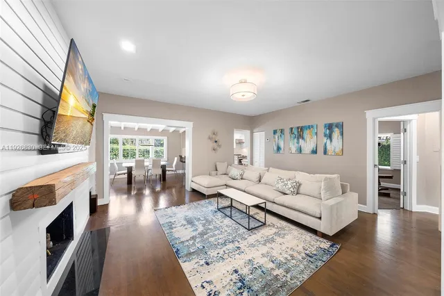 a living room with fireplace furniture and a flat screen tv