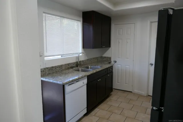 a kitchen with a sink cabinets and a window