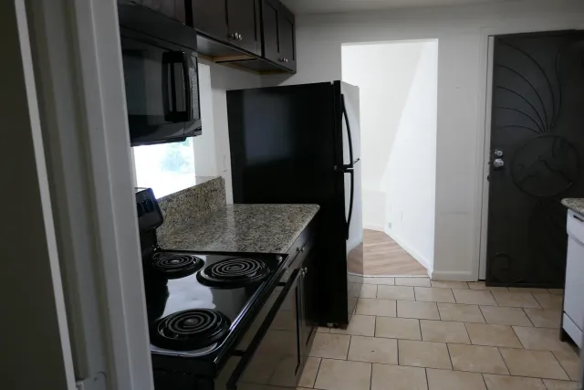 a kitchen with a refrigerator and a stove