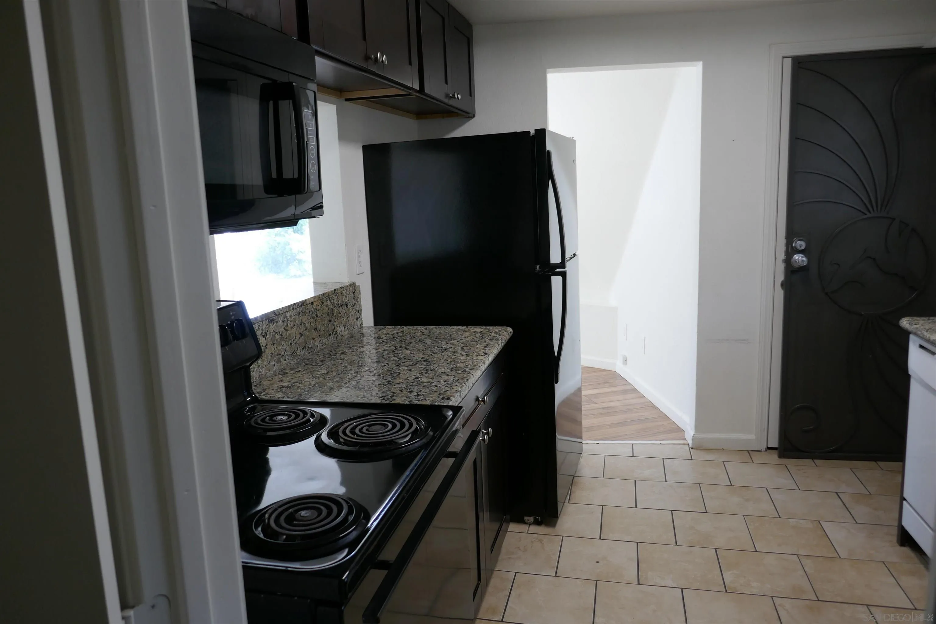 1015 Oro Street El Cajon, CA 92021 - Photo 4 of 14 a kitchen with a refrigerator and a stove