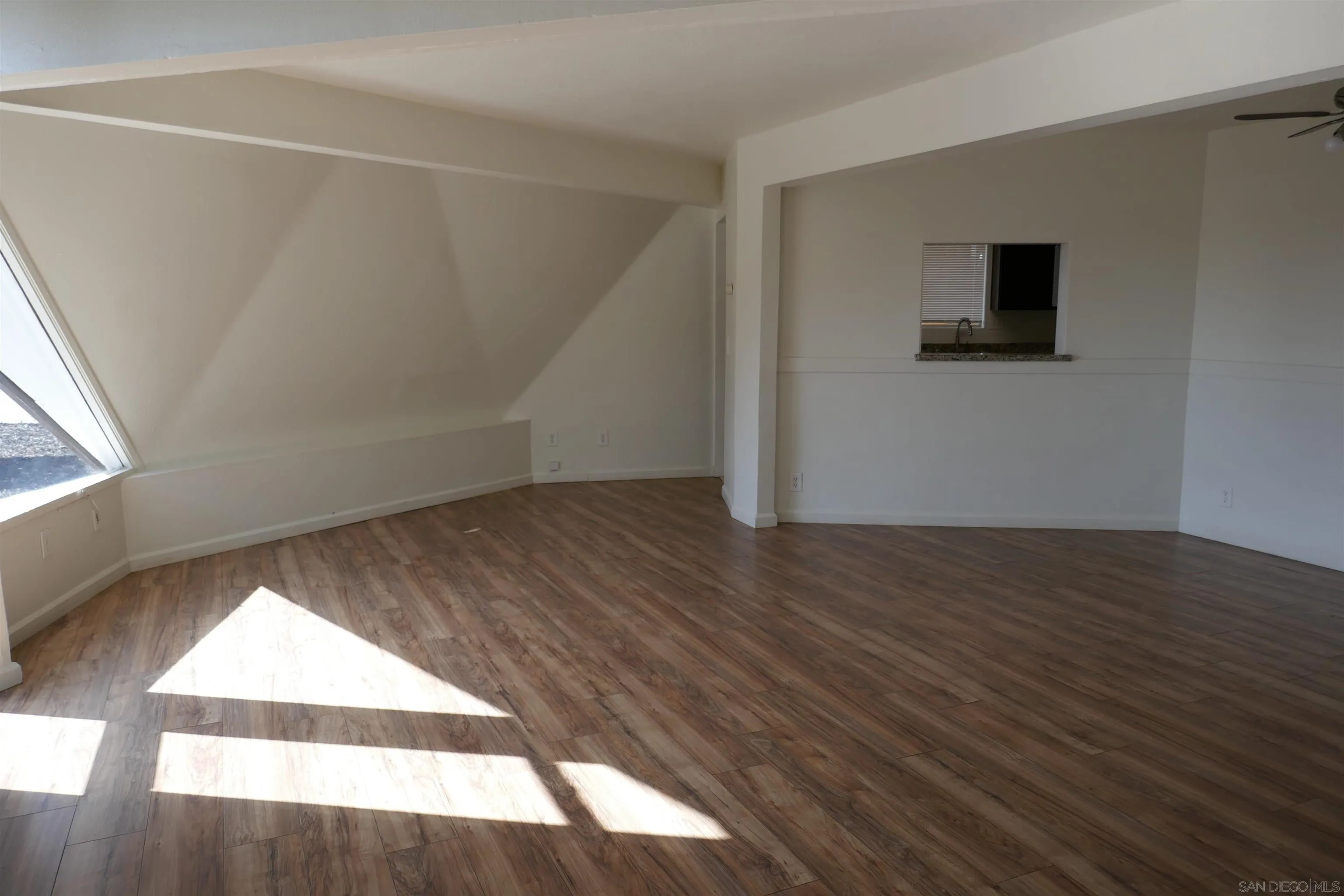 1015 Oro Street El Cajon, CA 92021 - Photo 9 of 14 an empty room with wooden floor and windows