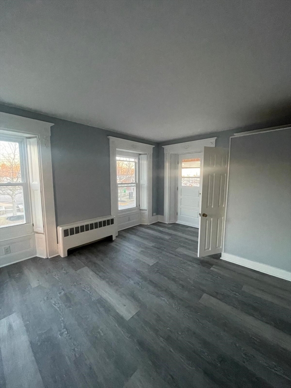 92 North Franklin Street, Unit 1 Holbrook, MA 02343 - Photo 2 of 25 an empty room with wooden floor and windows