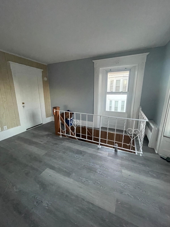 92 North Franklin Street, Unit 1 Holbrook, MA 02343 - Photo 4 of 25 an empty room with wooden floor and windows