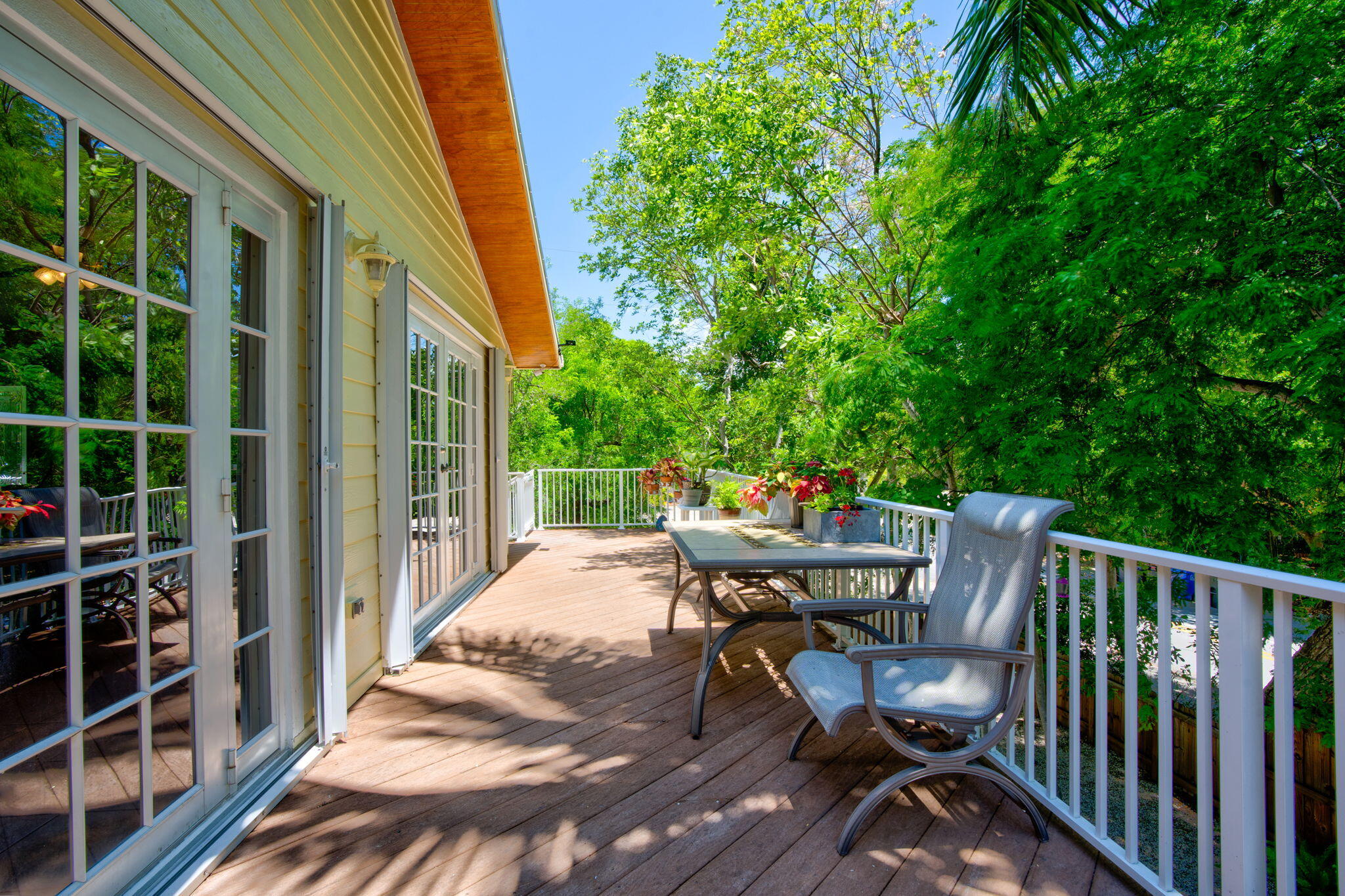125 South Rolling Hill Road Tavernier, FL 33070 - Photo 11 of 48 a roof deck with table and chairs and wooden floor