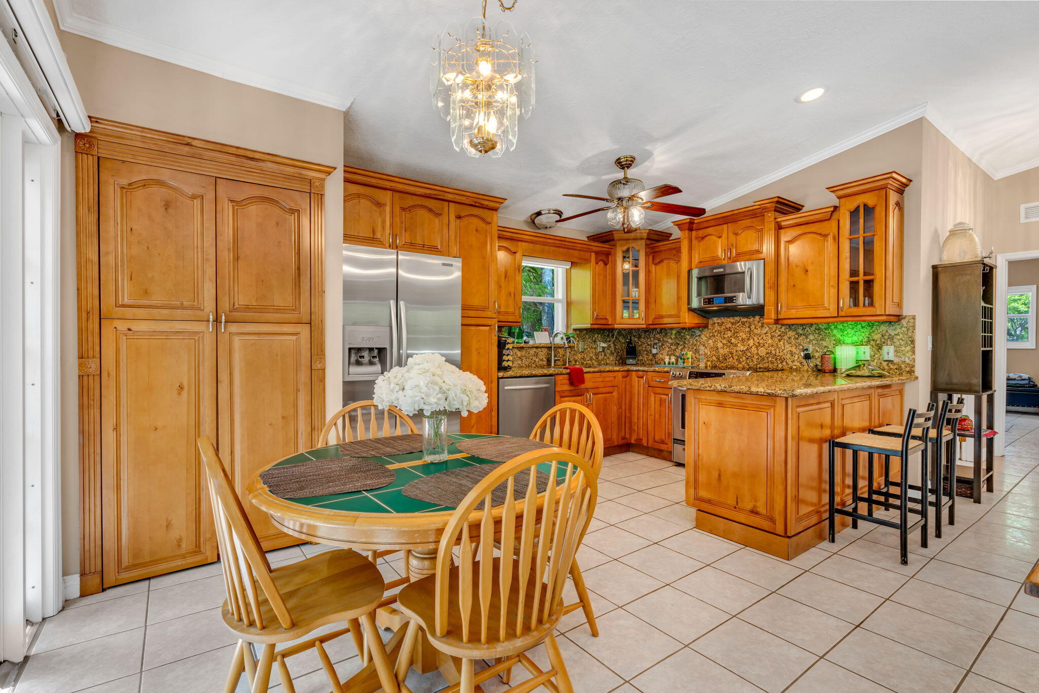 125 South Rolling Hill Road Tavernier, FL 33070 - Photo 13 of 48 a dining hall with a dining table and chairs