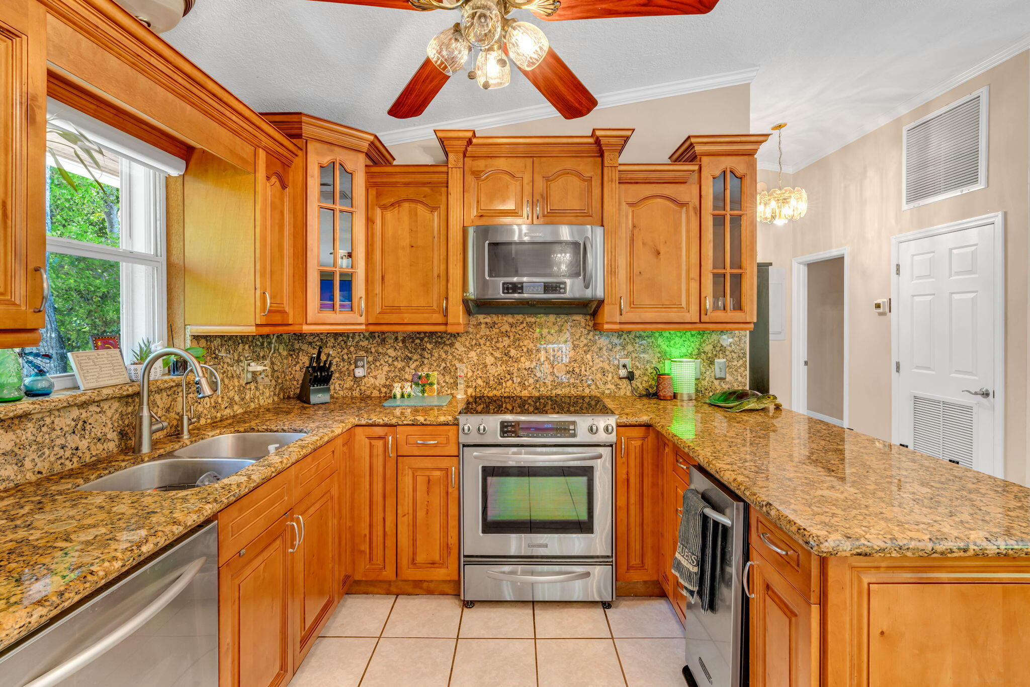 125 South Rolling Hill Road Tavernier, FL 33070 - Photo 15 of 48 a kitchen with stainless steel appliances granite countertop a sink and cabinets