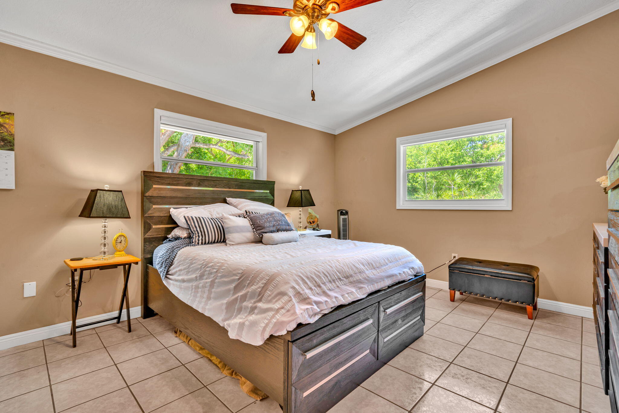 125 South Rolling Hill Road Tavernier, FL 33070 - Photo 20 of 48 a spacious bedroom with a bed and a chandelier