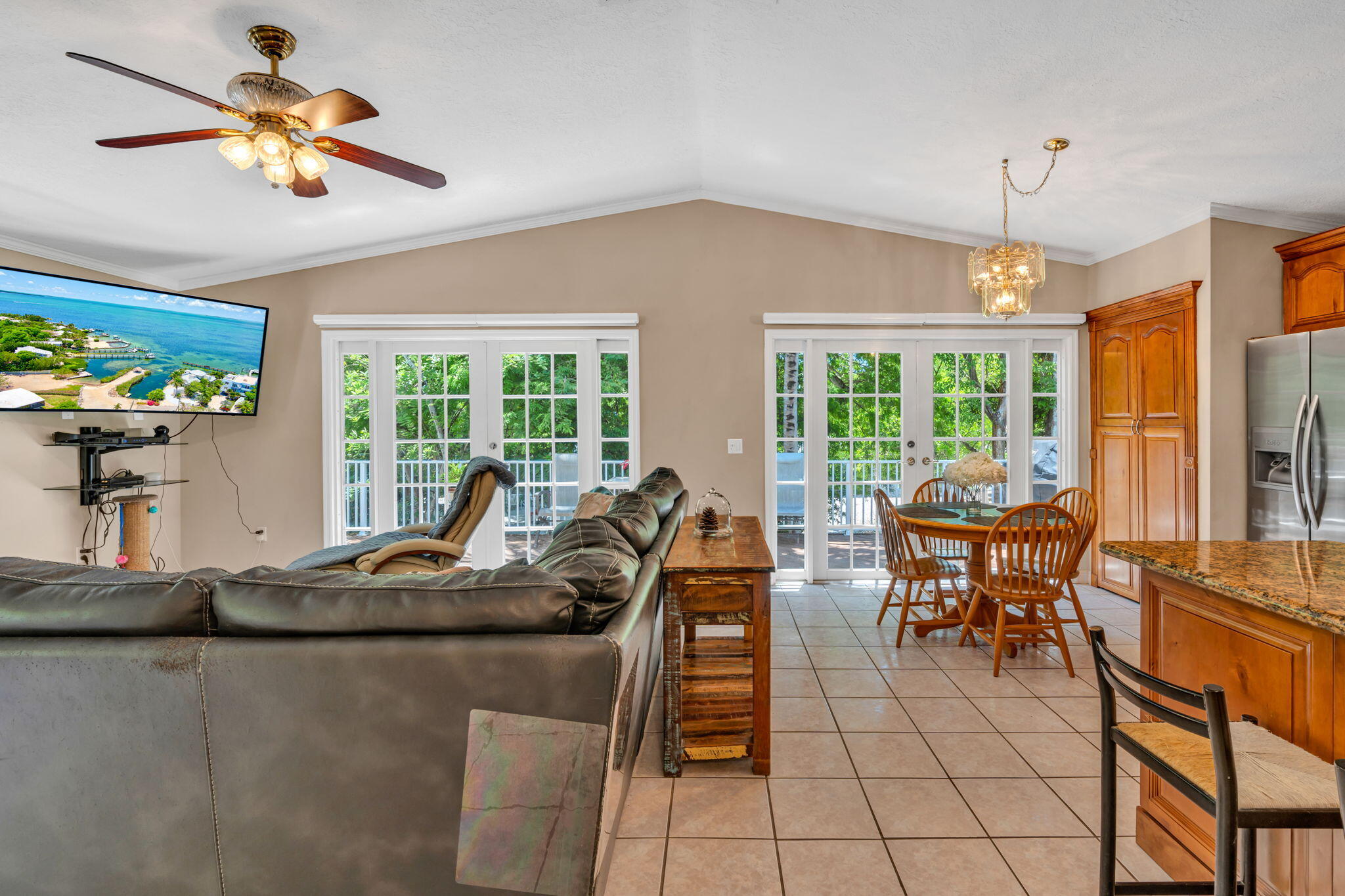 125 South Rolling Hill Road Tavernier, FL 33070 - Photo 7 of 48 a living room with furniture a flat screen tv and a large window