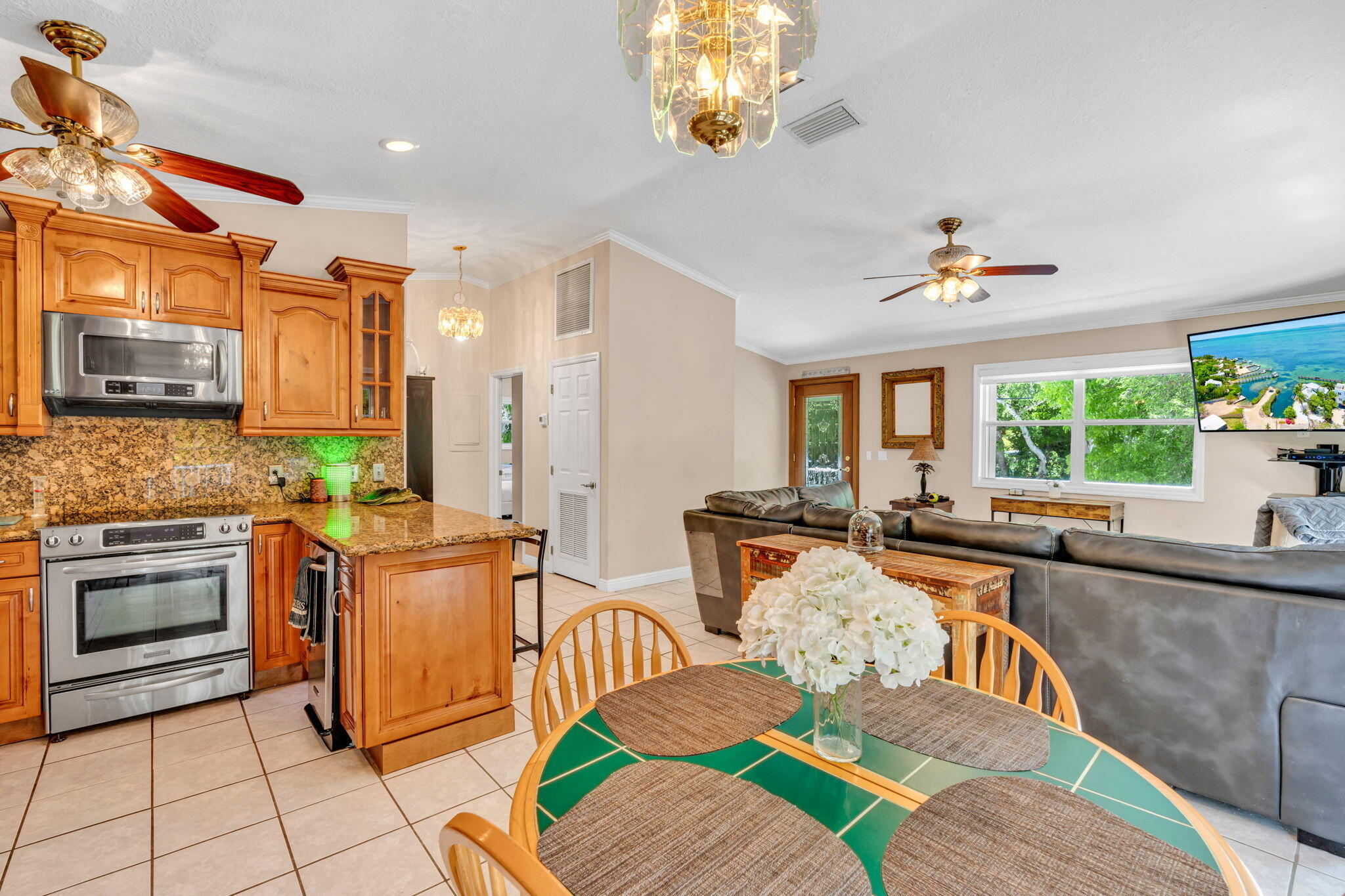 125 South Rolling Hill Road Tavernier, FL 33070 - Photo 8 of 48 a view of a dining room with furniture a chandelier and wooden floor