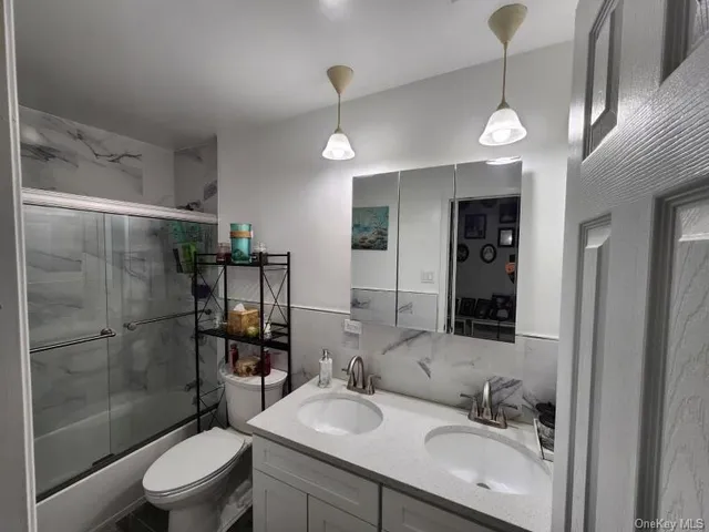 a bathroom with a sink toilet and shower