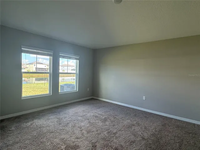 a bathroom with a granite countertop sink a mirror and shower