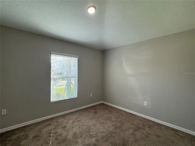 an empty room with closet and wooden door