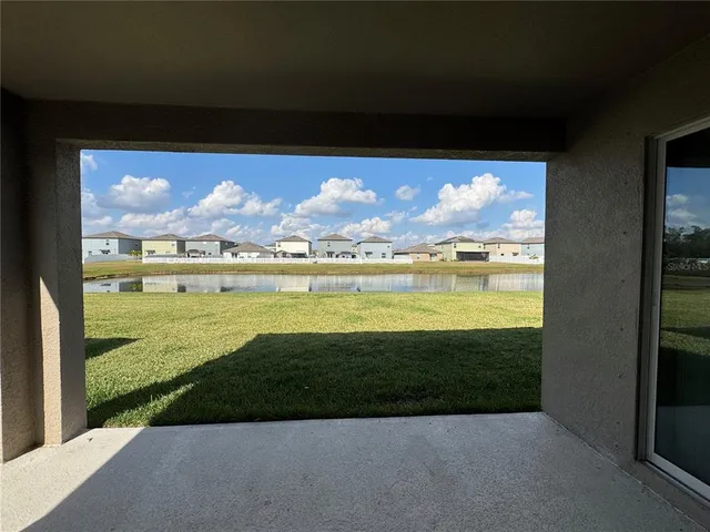 a view of a lake with houses in the back