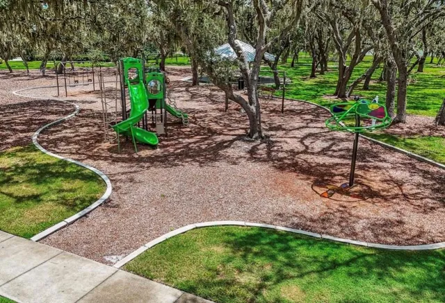 an aerial view of a house with a yard and lake view