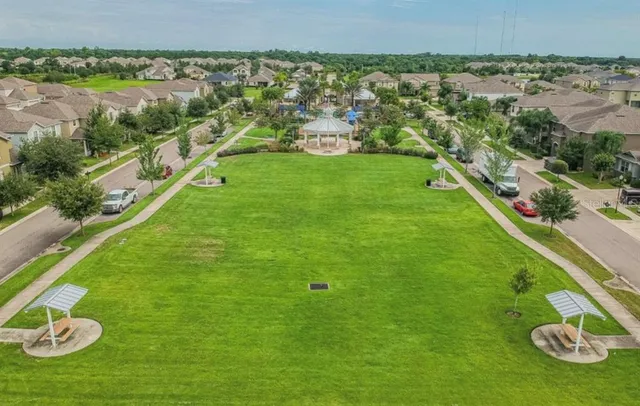 an aerial view of a house with garden space and street view