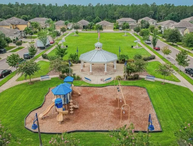a view of a house with swimming pool and a garden