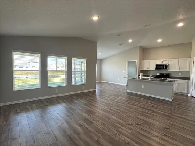 a view of kitchen with sink and wooden floor
