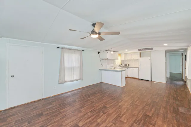 a view of a kitchen with wooden floor and a kitchen