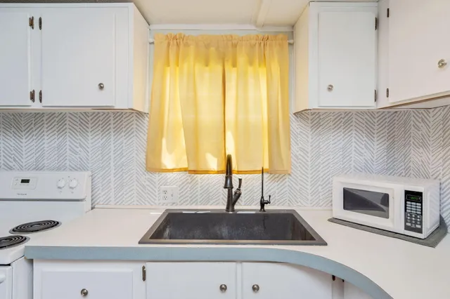 a kitchen with a sink and a microwave