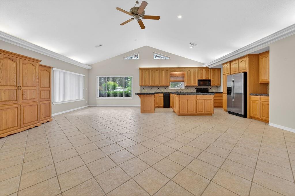 2436 Lakefront Shores Road Athens, TX 75752 - Photo 8 of 32 a open kitchen with stainless steel appliances granite countertop a refrigerator stove top oven and sink