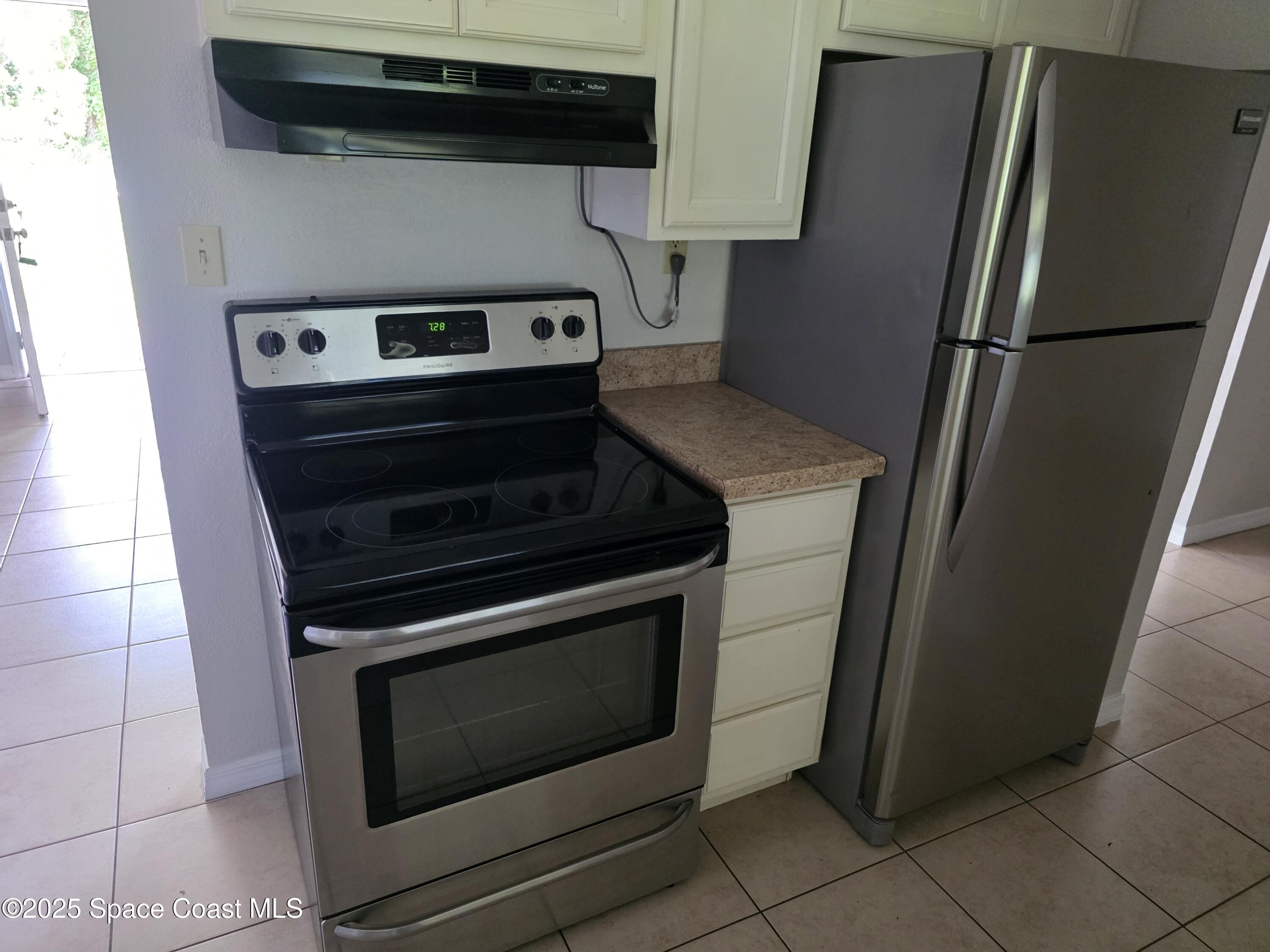 7160 Bevil Avenue Cocoa, FL 32927 - Photo 2 of 10 a stove top oven sitting inside of a kitchen