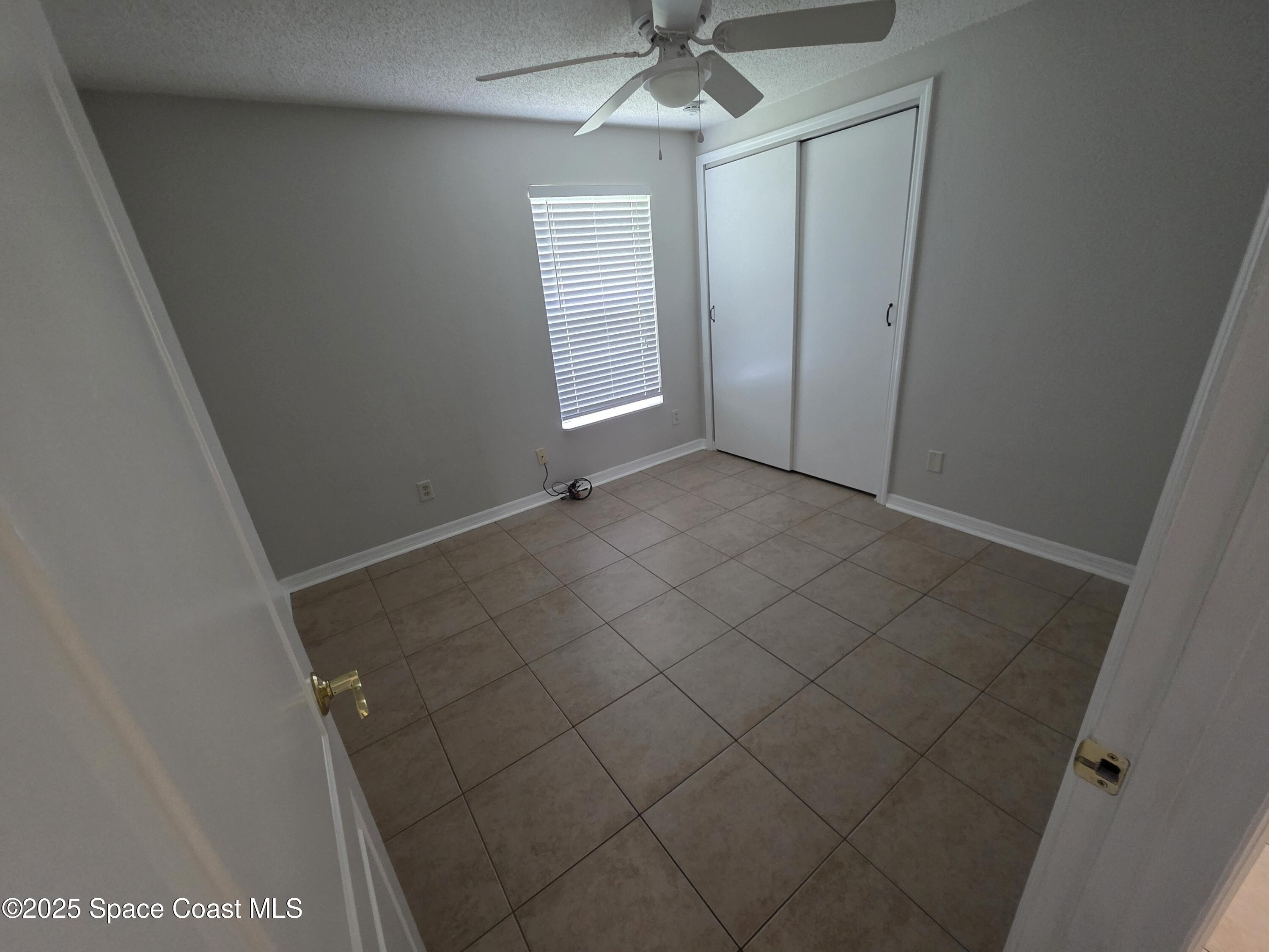 7160 Bevil Avenue Cocoa, FL 32927 - Photo 10 of 10 an empty room with a empty space and a ceiling fan