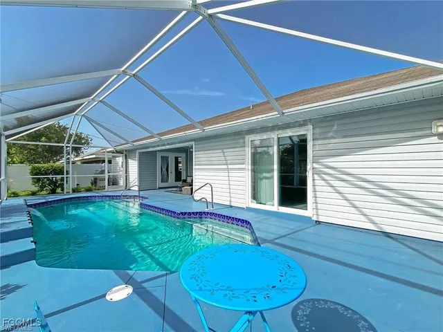 a view of a house with backyard porch and furniture