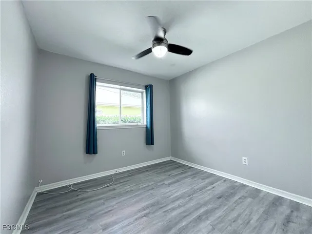 a view of a chair and table in backyard of the house