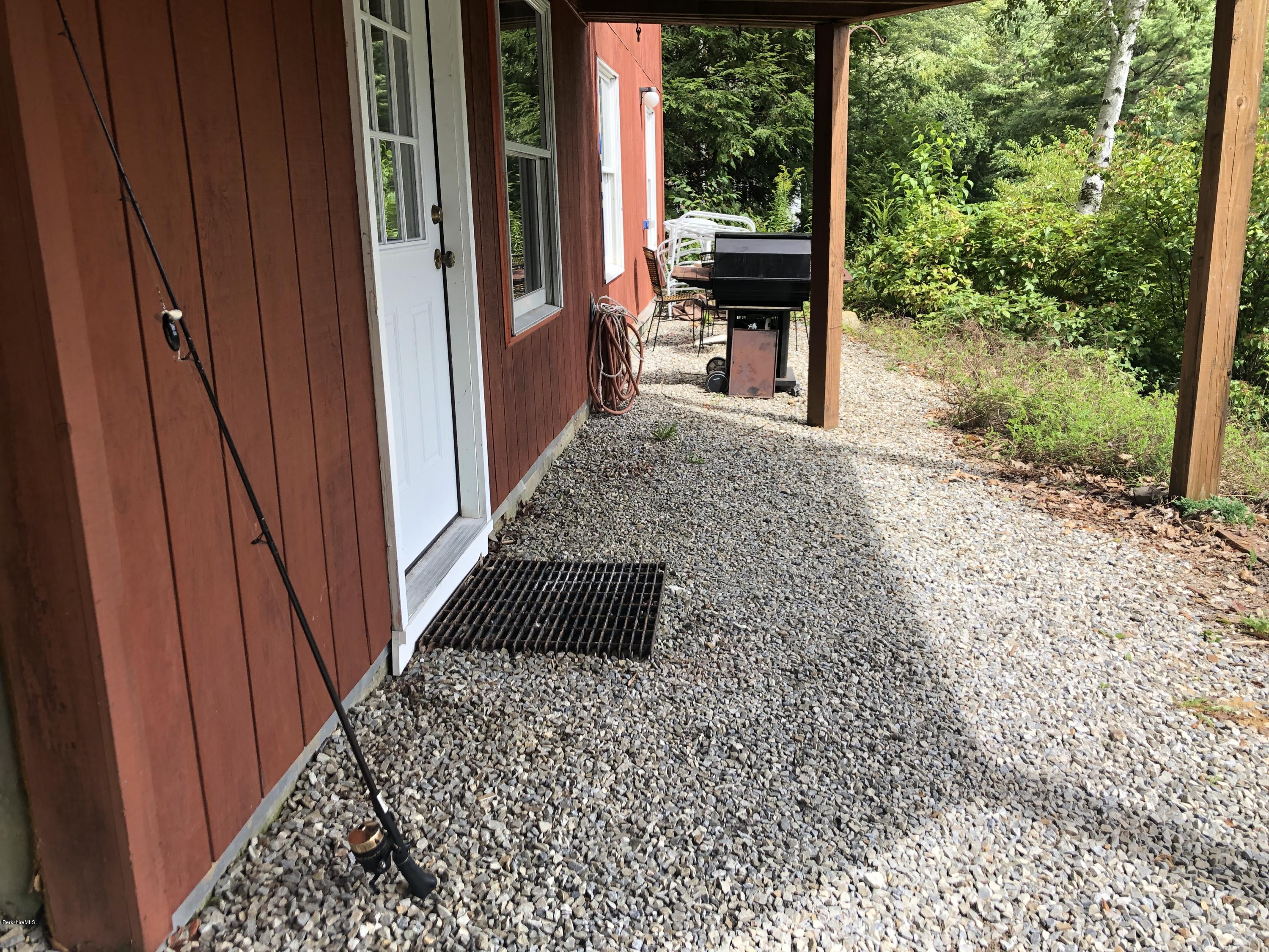 8 Dowd Road Monterey, MA 01245 - Photo 23 of 25 a view of a porch with wooden floor and outdoor seating