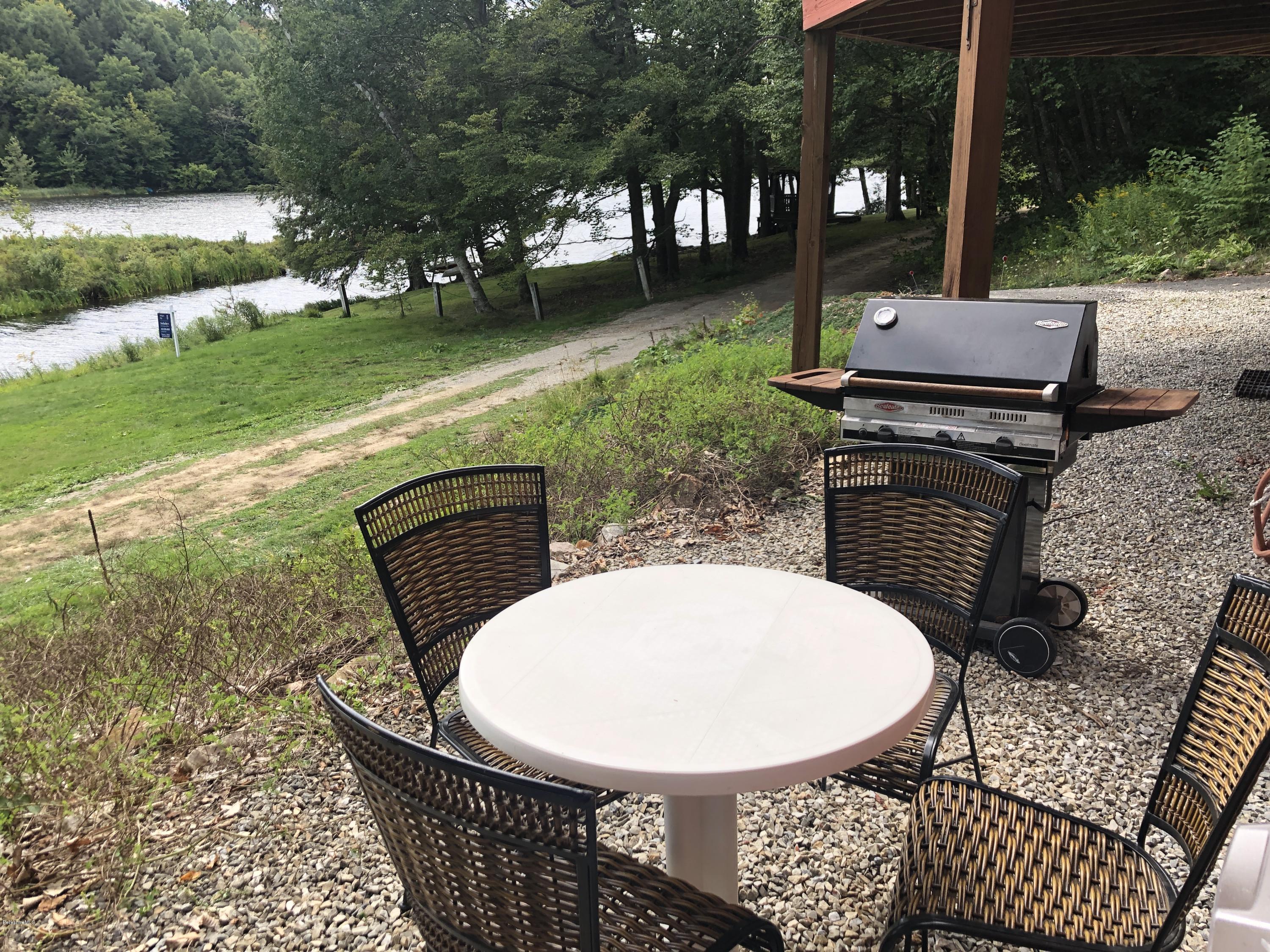 8 Dowd Road Monterey, MA 01245 - Photo 24 of 25 a view of a chairs and table in backyard