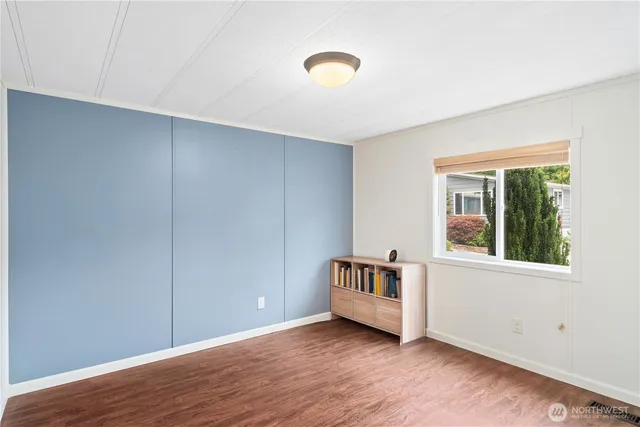 a view of a white house with a yard and potted plants