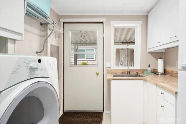 a view white cabinets and wooden floor