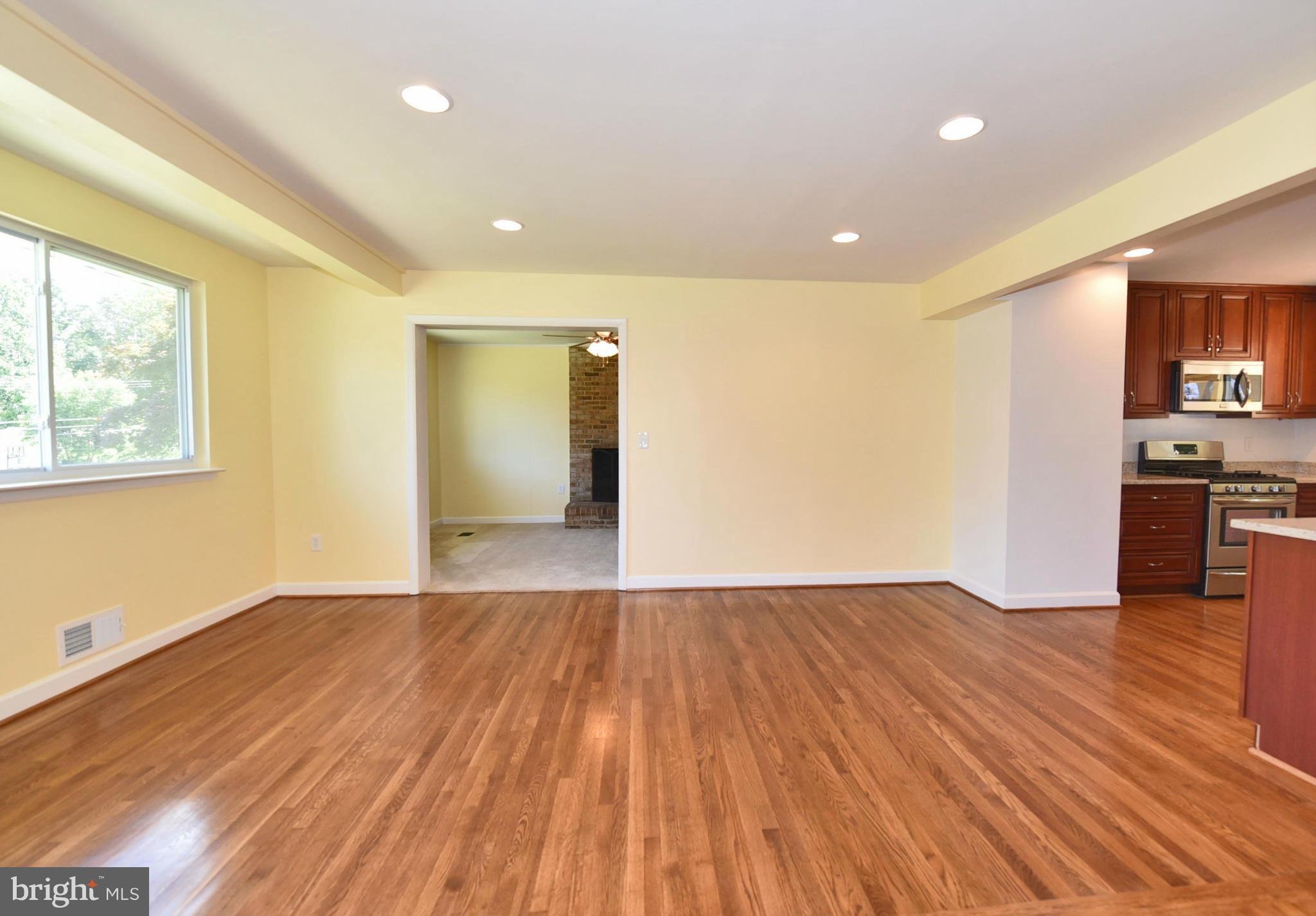 13516 Collingwood Terrace Silver Spring, MD 20904 - Photo 11 of 29 a view of empty room with wooden floor and kitchen